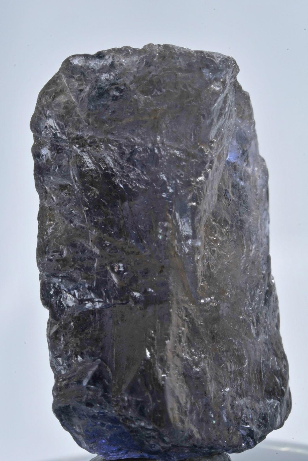 Rough cordierite crystal, violet-blue from one face and yellow-grey from another
