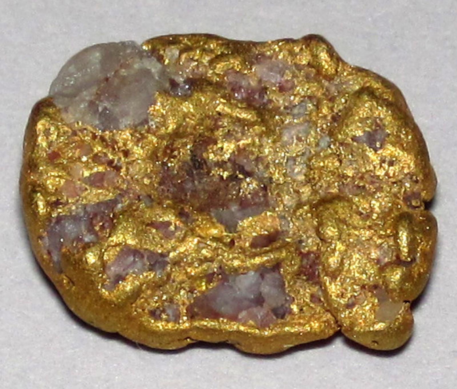 Gold-quartz placer nugget from Lead, South Dakota, with quartz still attached