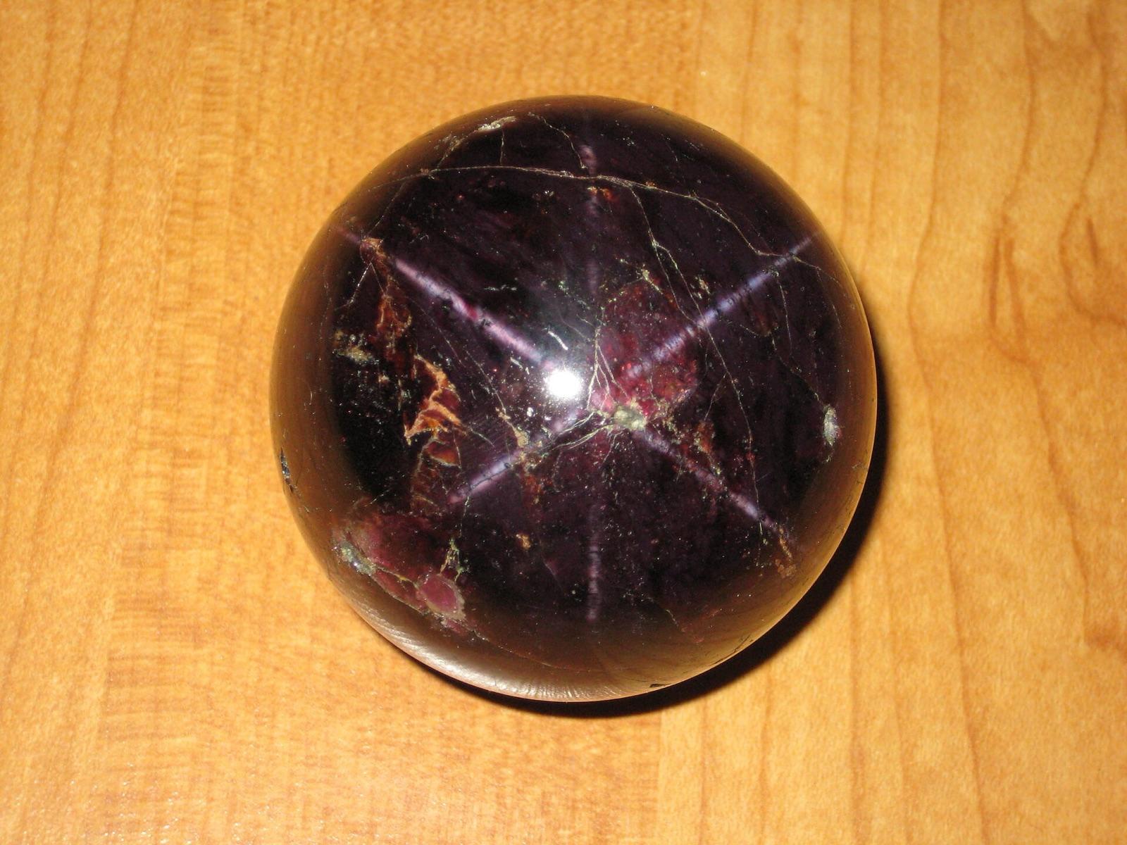 Idaho star garnet cut as a high dome, showing the six-rayed star