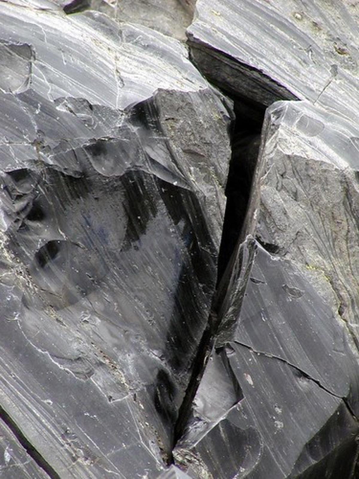 Obsidian outcrop face showing flow banding in the glass