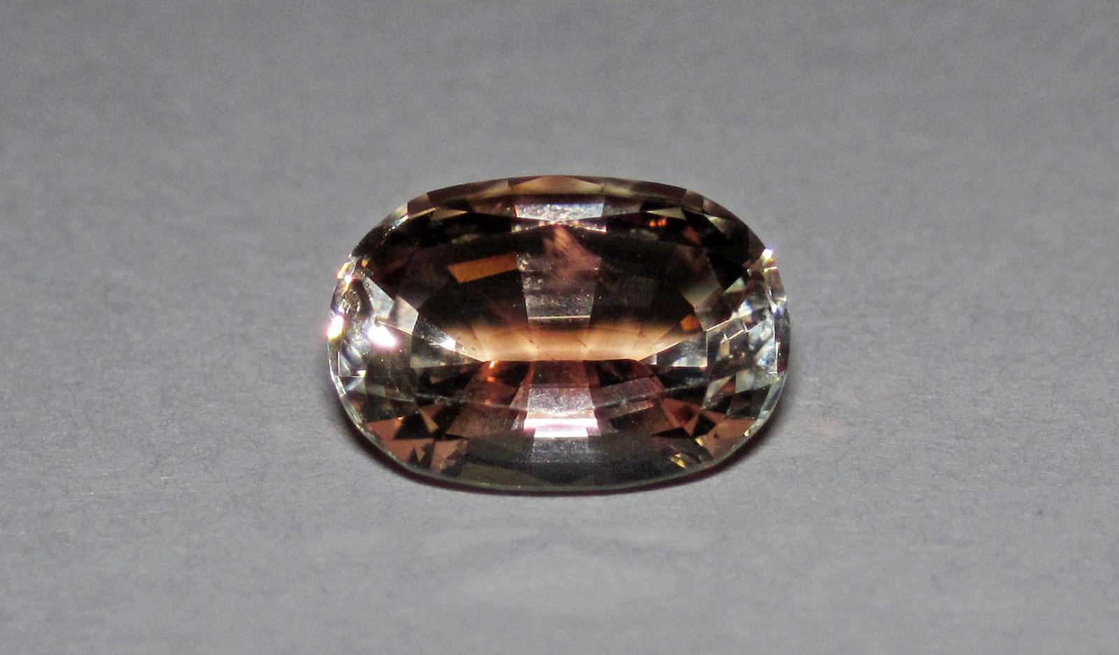 Faceted Oregon sunstone with warm red-orange body colour