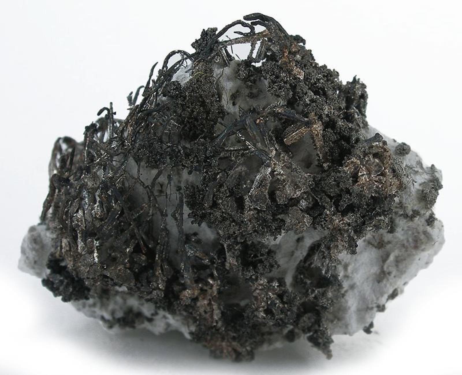Native silver tarnished dark, showing the black surface it takes in the field