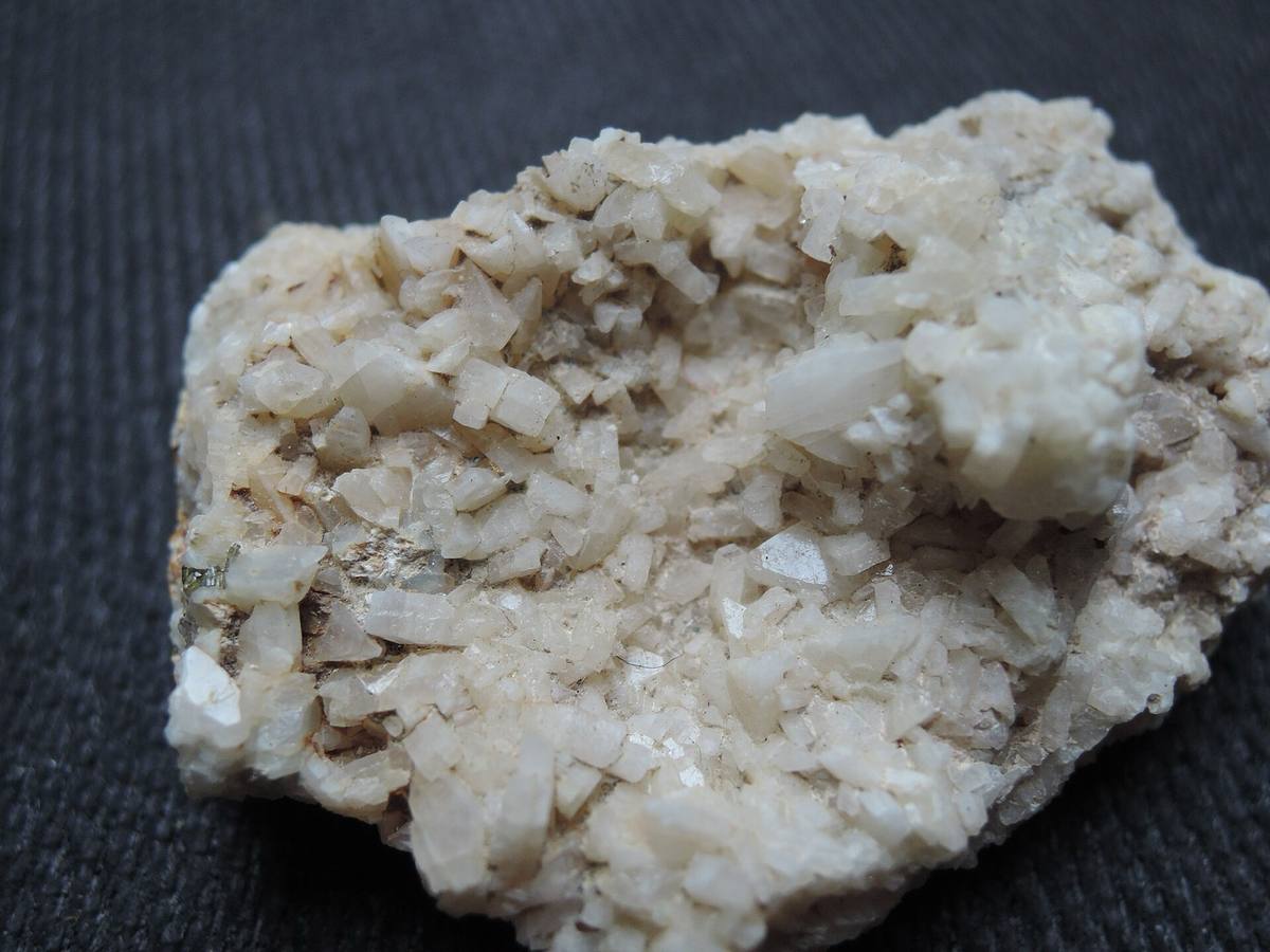 White blocky albite crystal crust on rock