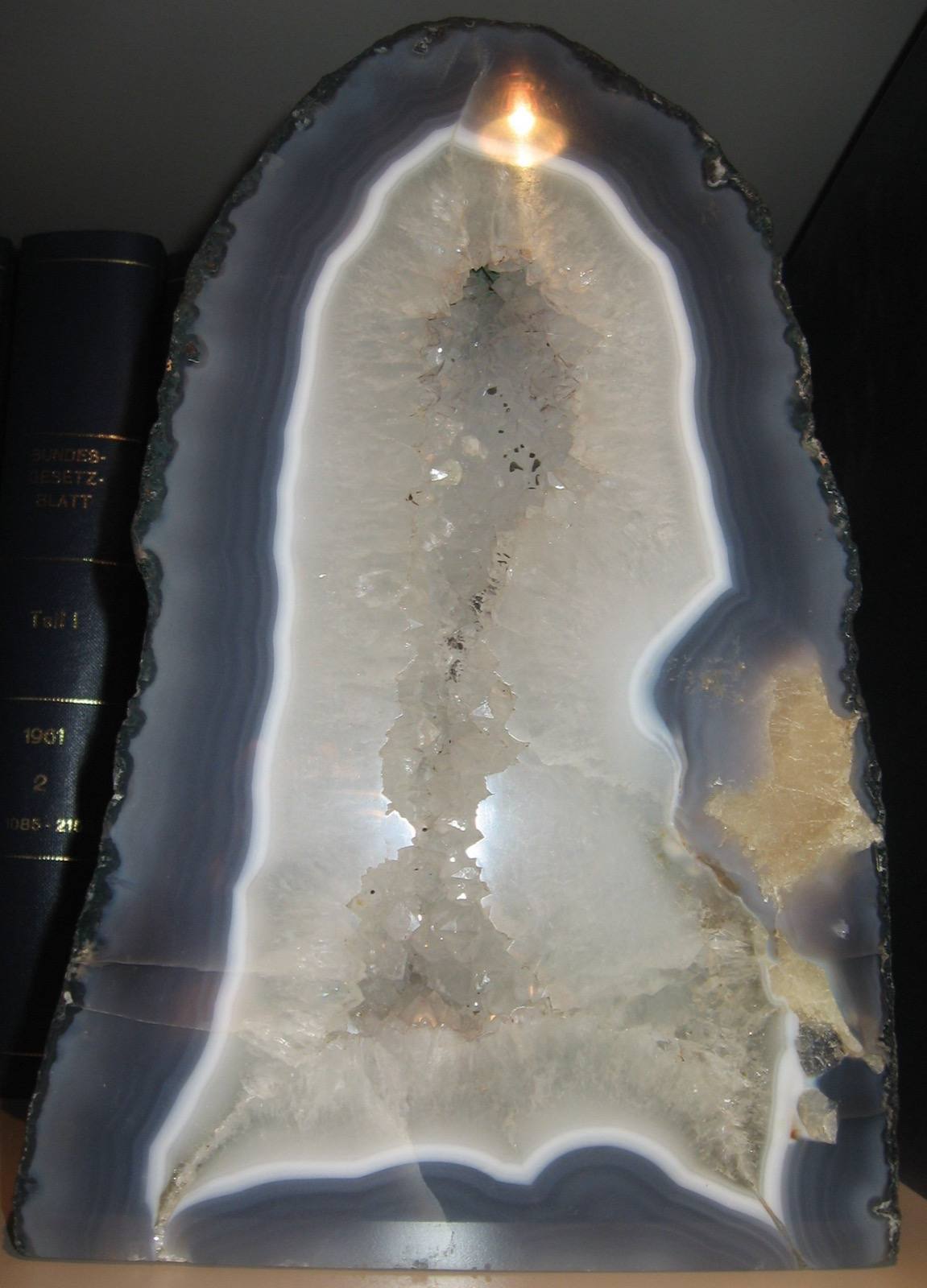 Blue-grey agate geode lined with quartz crystals