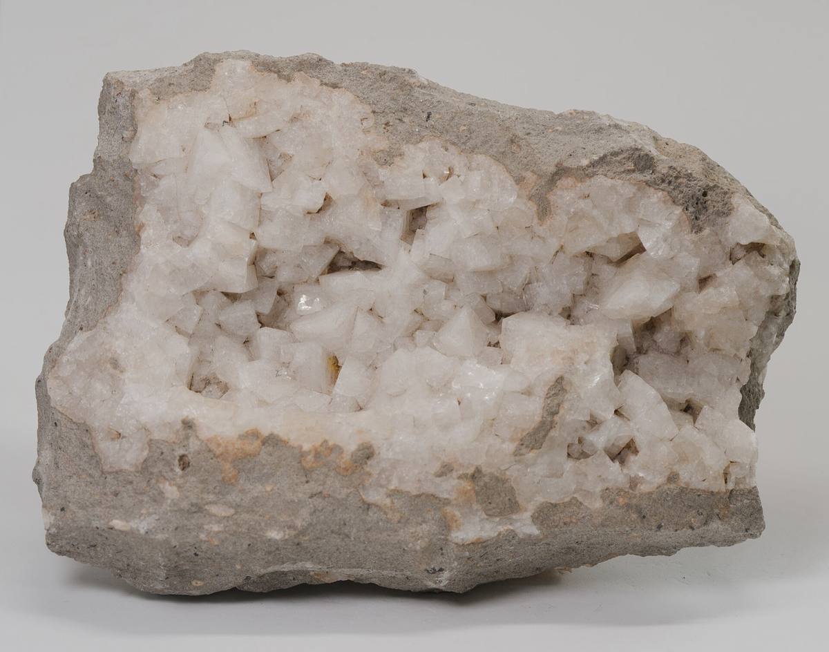 White chabazite crystals lining a vug in phonolite