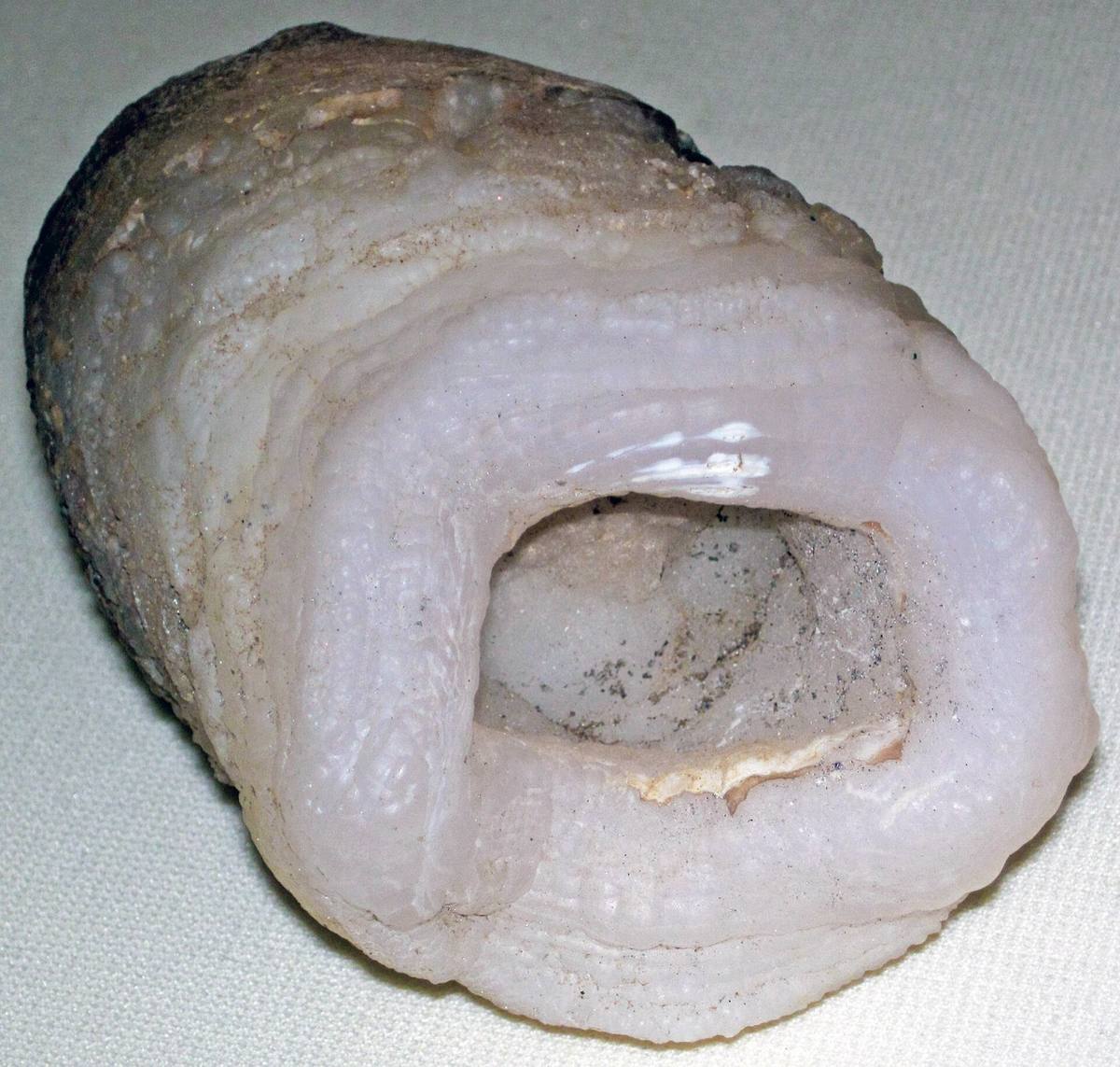 White-grey chalcedony crust around a hollow, Round Mountain, Arizona