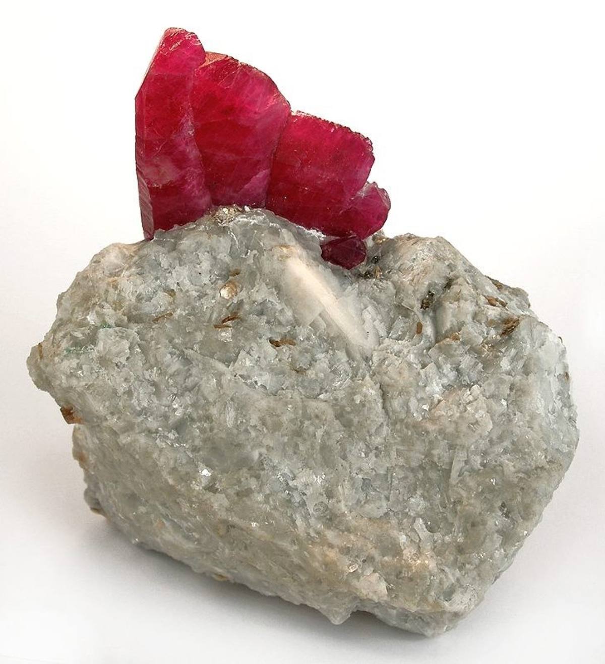 Red ruby crystal group on white matrix