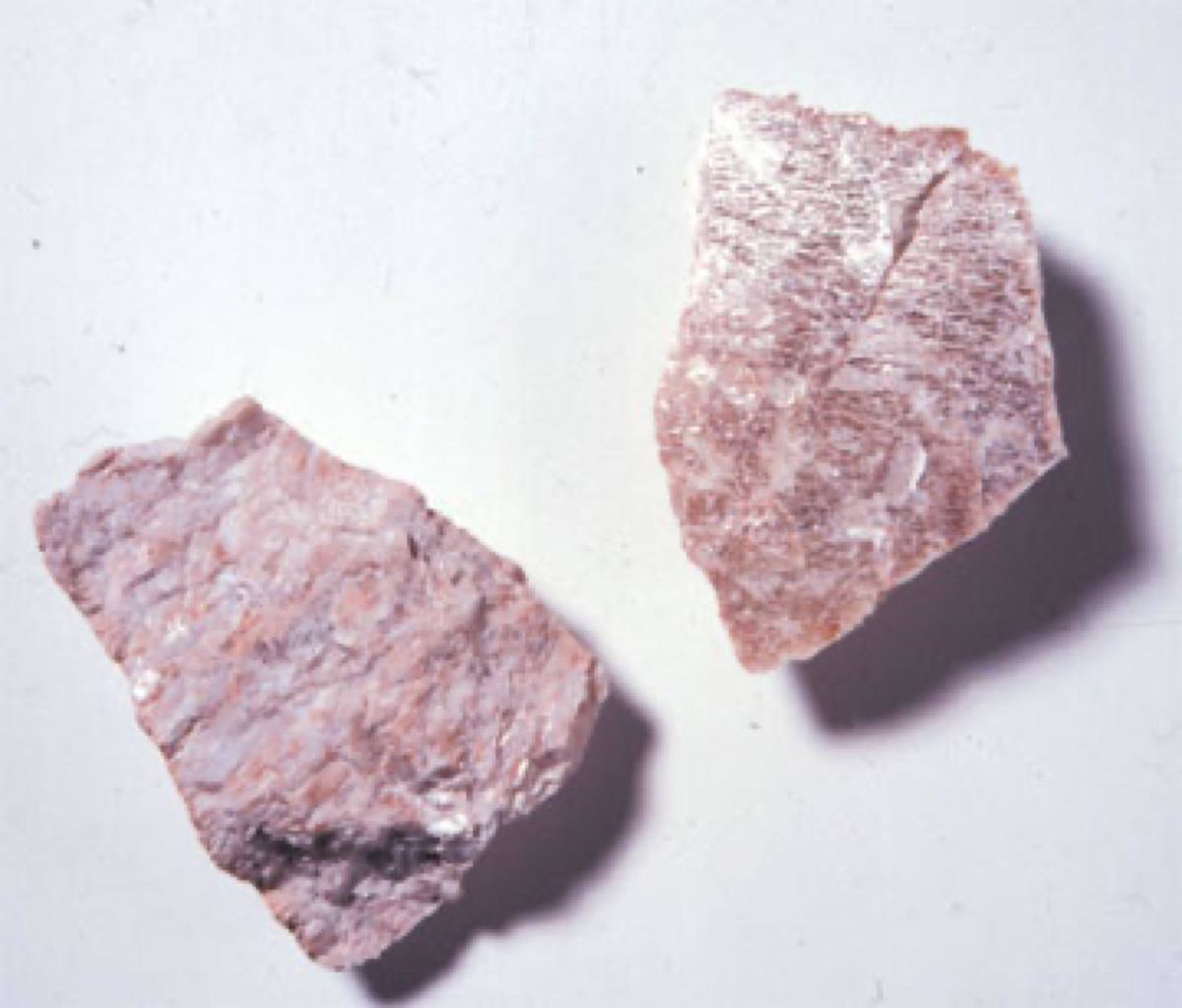 Pink potassium feldspar cleavage fragments showing flat cleavage planes