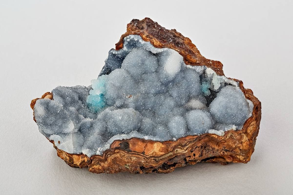 Geode lined with quartz crystals on a limonite base