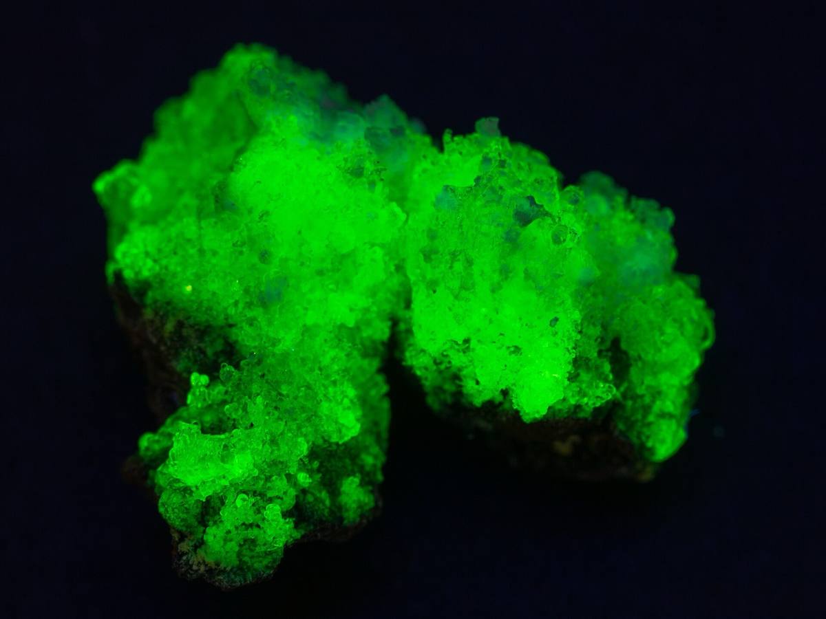 Hyalite Opal fluorescing under ultraviolet light