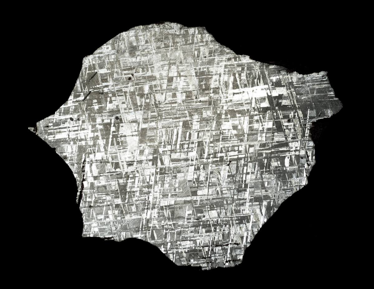 Etched Gibeon meteorite slice, kamacite pattern across the face