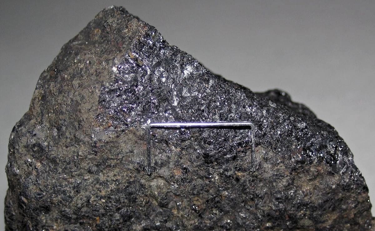 Lodestone holding a steel staple upright by its own magnetism, Adirondacks, New York