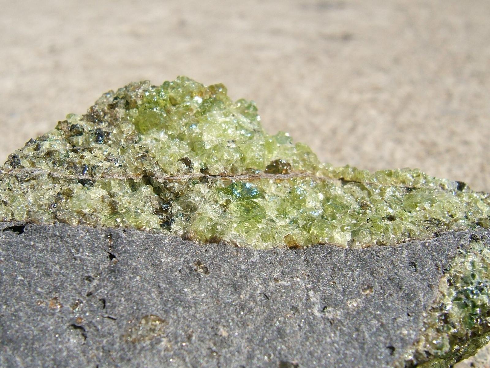 Green peridot grains on vesicular basalt, San Carlos, Arizona