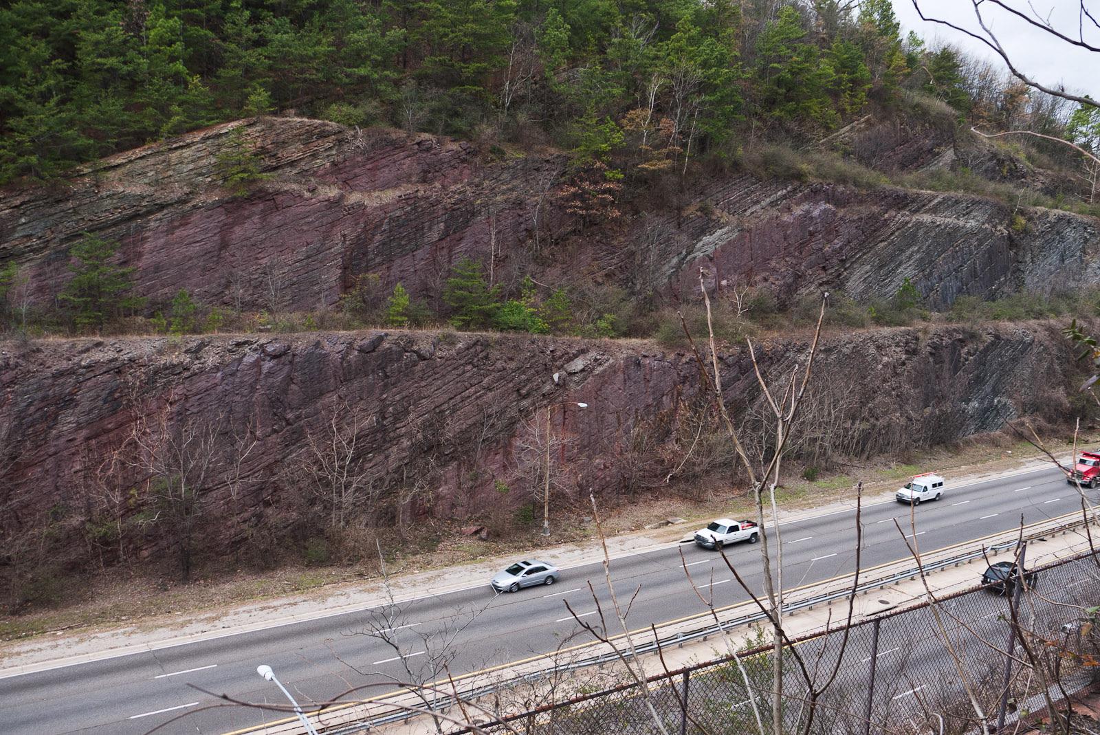 The Red Mountain Expressway Cut in Birmingham, exposing the tilted red iron-ore beds of the Red Mountain Formation, Jefferson County, Alabama