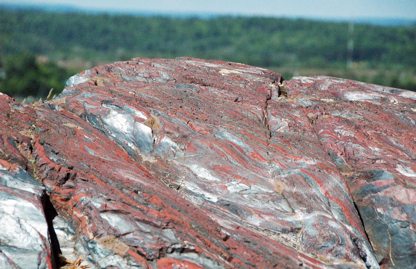 The banded red jasper and silver hematite of the jaspilite outcrop at Jasper Knob, Ishpeming