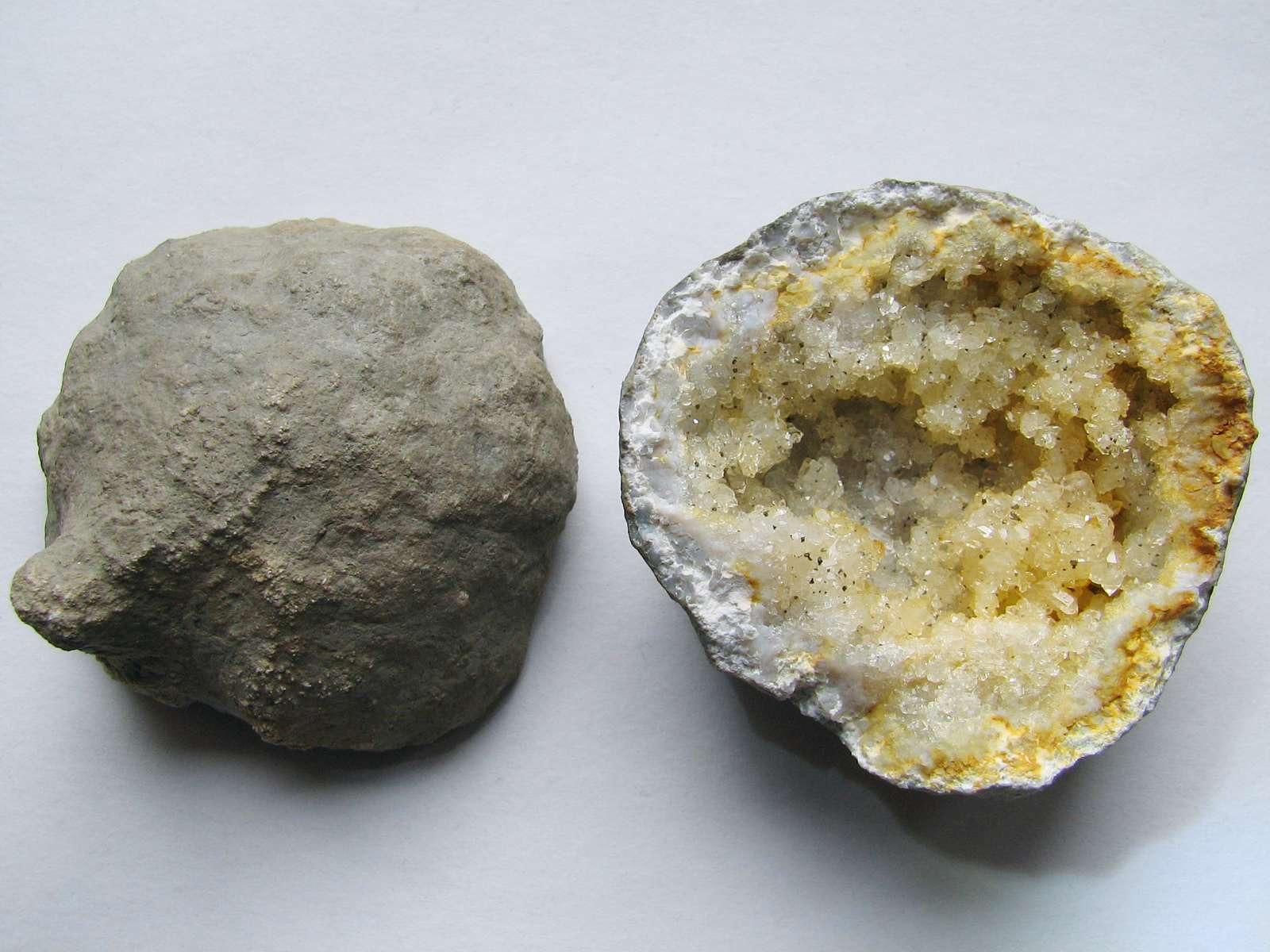 A Keokuk geode shown as an unbroken gray nodule beside its quartz crystal lined interior cavity, like the geodes that weather out of the Warsaw Formation and wash into creek gravels around Alexandria and Wayland.