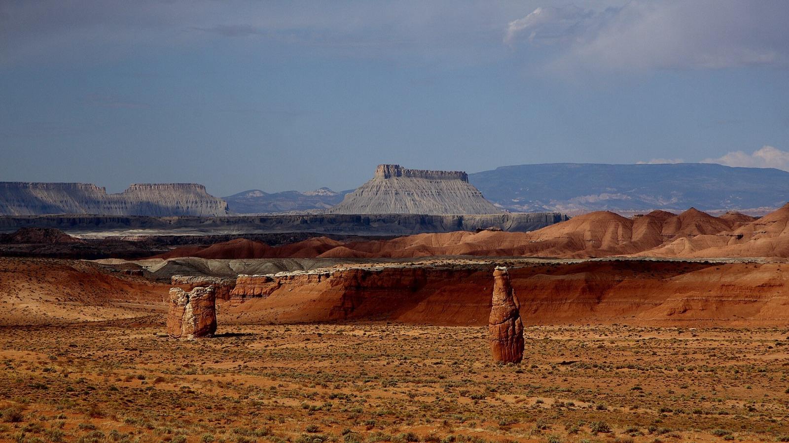Desert badlands with Factory Butte in the background, north of town on Route 24, at Hanksville, Wayne County, Utah